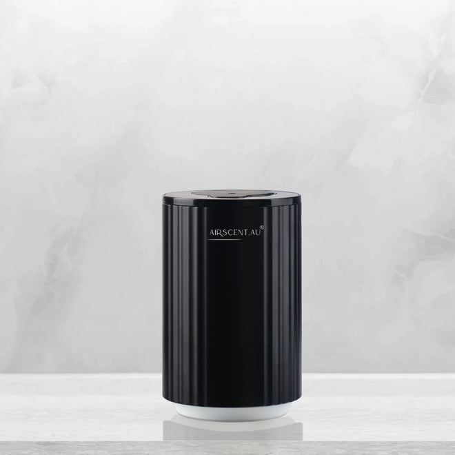 Compact AirScent portable diffuser with sleek design, suitable for cars and small spaces.